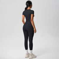 Person wearing a black athletic outfit on a white background