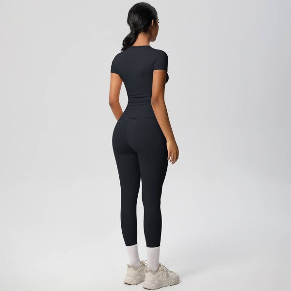 Person wearing a black athletic outfit on a white background