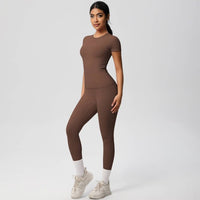 Woman wearing a brown athletic outfit on a white background