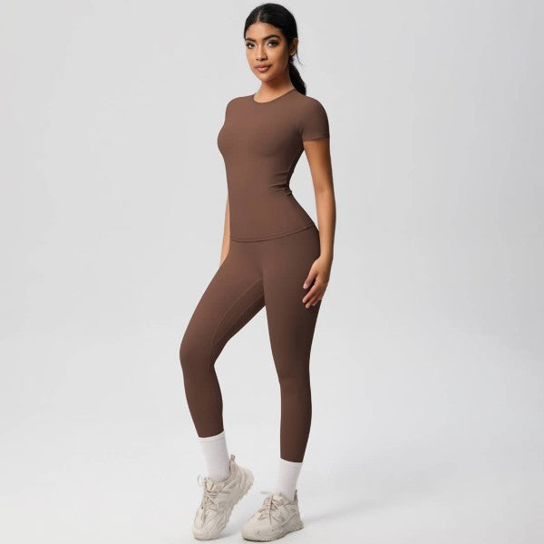 Woman wearing a brown athletic outfit on a white background