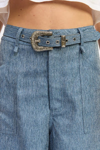 Close-up of blue denim pants with a belt and buckle.