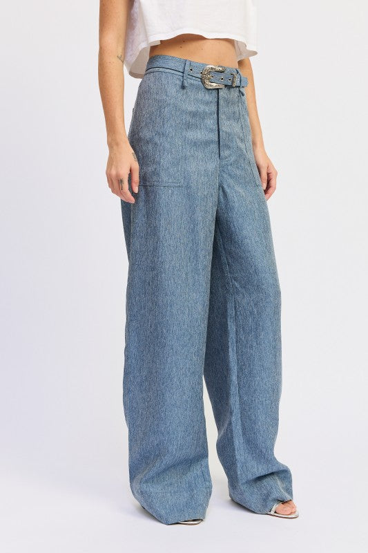 Blue denim wide-leg pants worn by a person on a white background