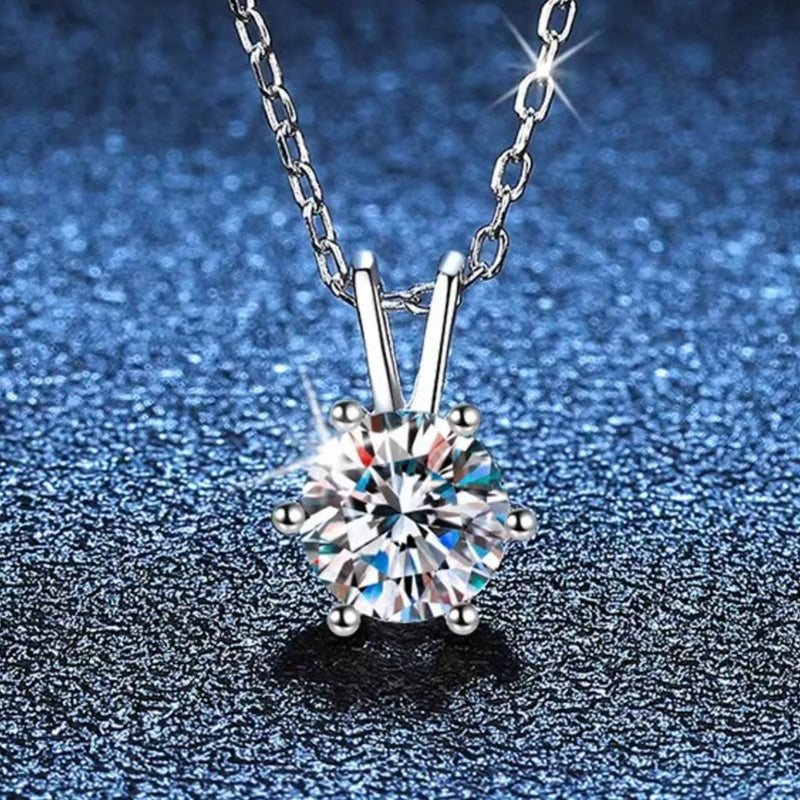 Silver necklace with a diamond pendant on a blue textured background