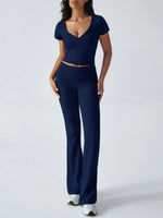 Woman wearing a navy blue outfit on a white background