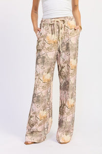 Camouflage-patterned pants worn by a person on a white background