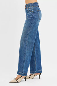 Blue jeans worn by a person on a white background