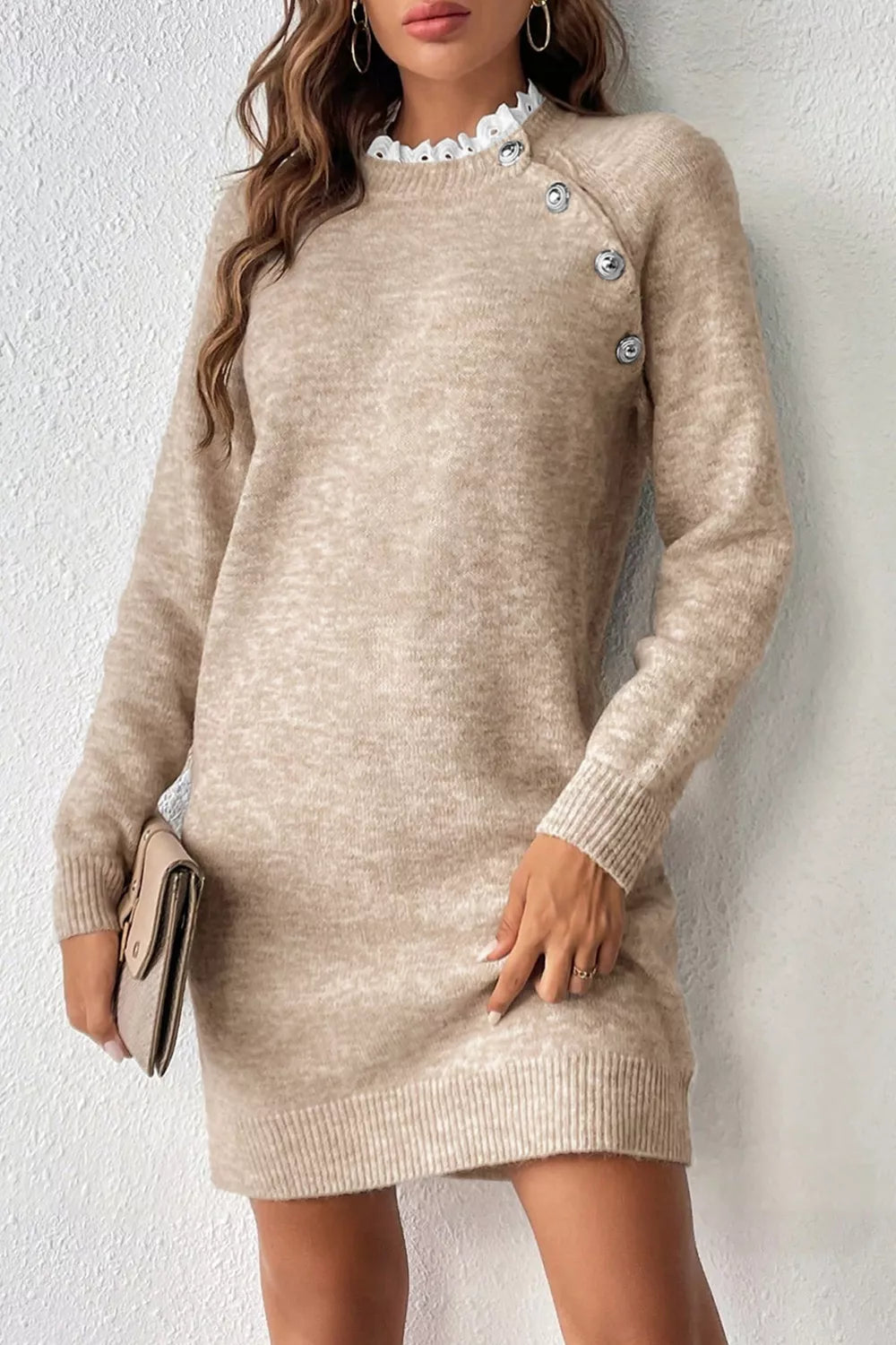 Beige sweater dress worn by a person against a white background