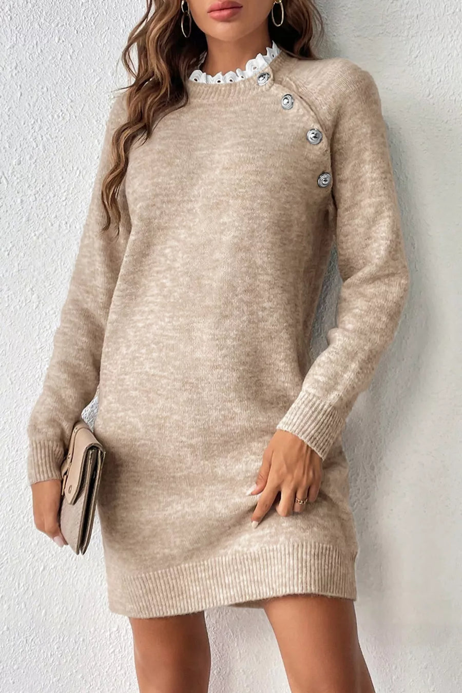 Beige sweater dress worn by a person against a white background