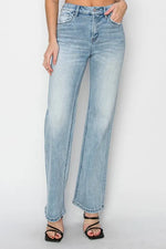Light blue jeans worn by a person on a white background