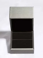 Modern side table with metallic top and black base on a white background
