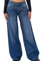 A person wearing high-waisted, wide-leg blue denim jeans with a black long-sleeve top, shown from the waist down against a plain white background.
