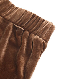 Close-up of brown velvet fabric with a white background