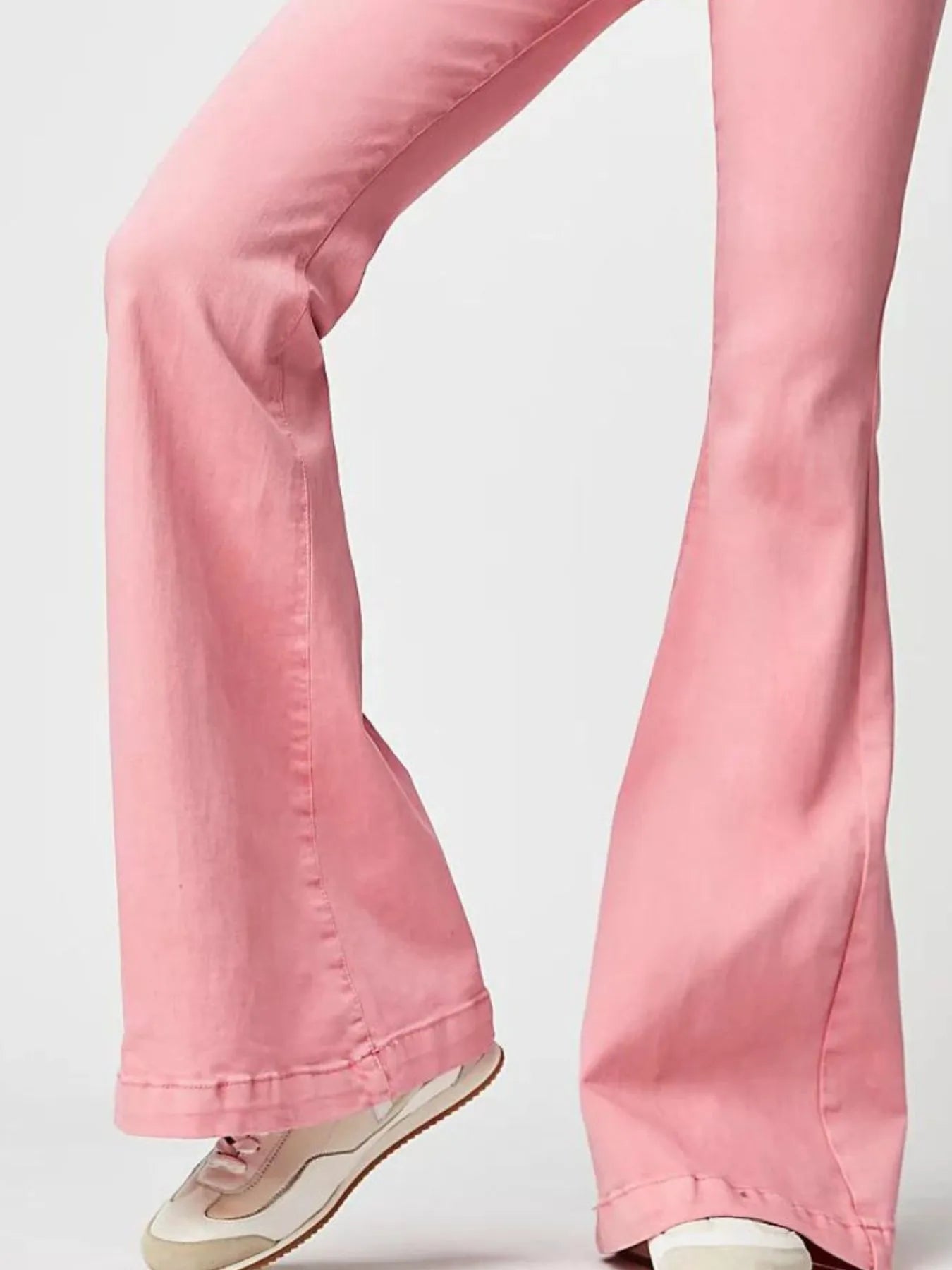Pink flared jeans on a white background