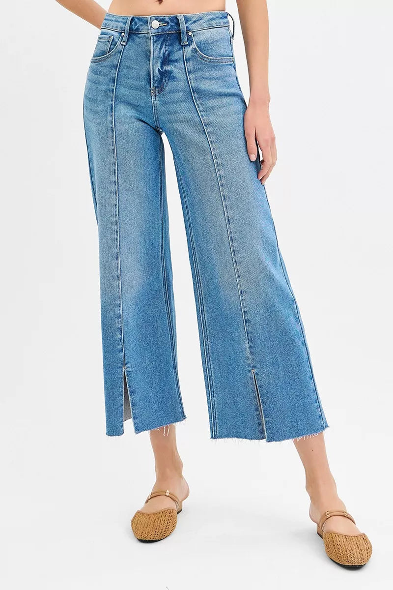 Blue jeans worn by a person on a white background
