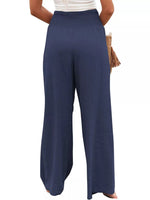 Navy blue wide-leg pants worn by a person on a white background