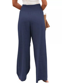 Navy blue wide-leg pants worn by a person on a white background