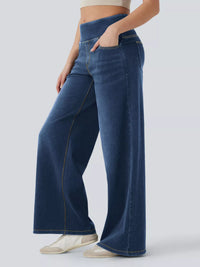 Person wearing blue wide-leg jeans on a light gray background