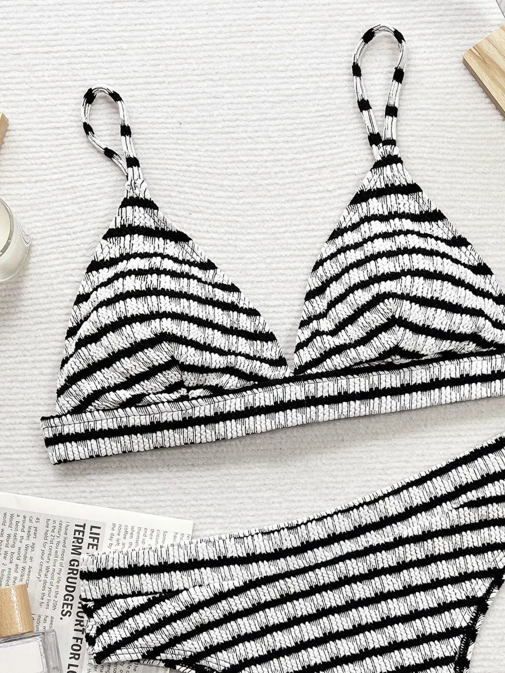 Black and white striped bikini top on a light surface