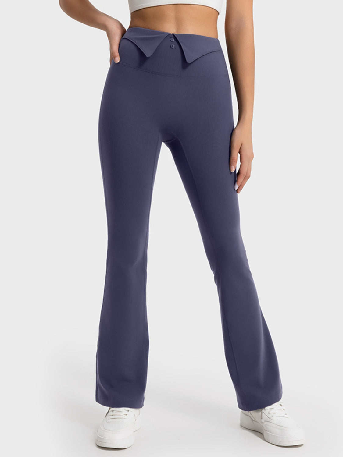 Purple flared pants worn by a person on a white background