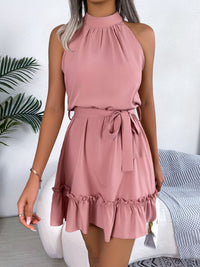 Woman wearing a pink dress with a white background