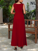 Woman in a red dress walking outdoors with plants and a bench in the background