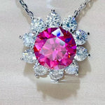 Necklace with a pink gemstone and clear stones on a light background