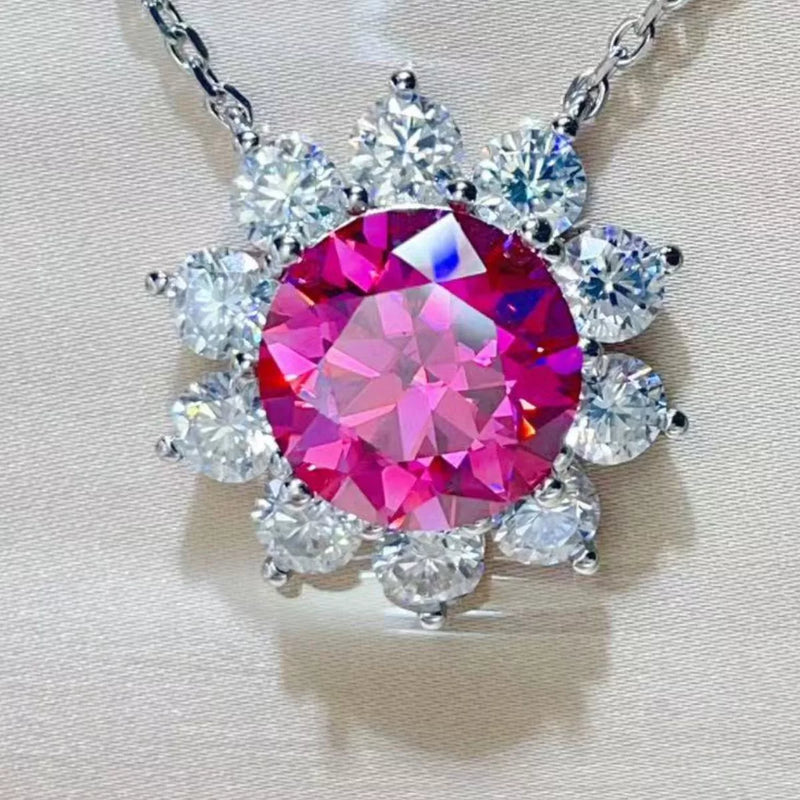 Necklace with a pink gemstone and clear stones on a light background