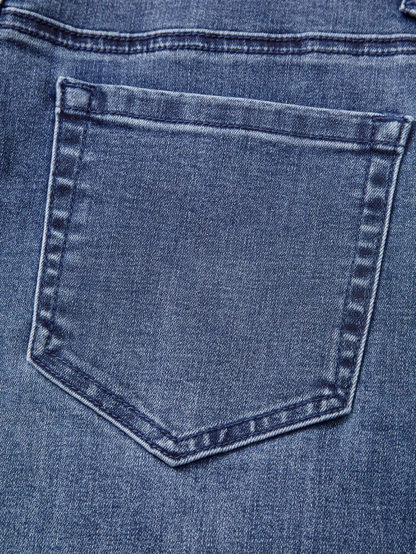 Close-up of a blue denim pocket with stitching details
