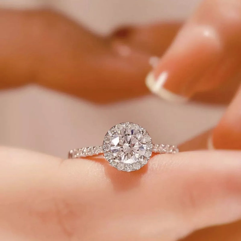 Diamond ring on a hand with a blurred background