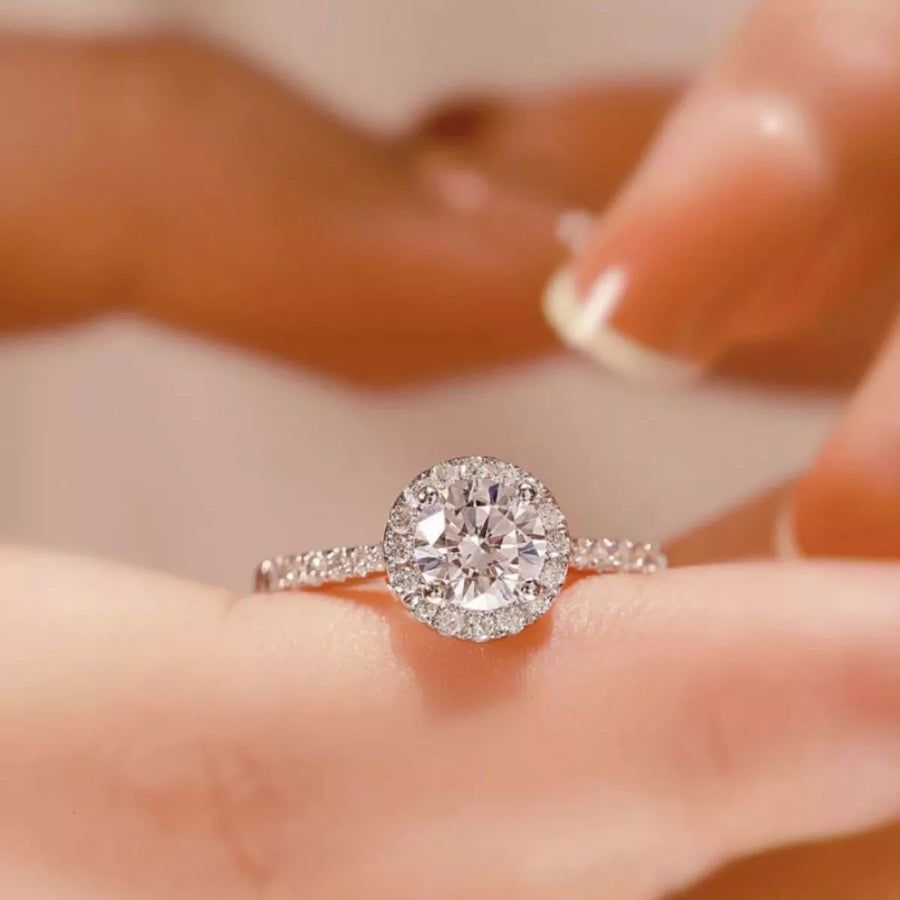 Diamond ring on a hand with a blurred background