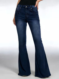 Blue flared jeans worn by a person on a white background