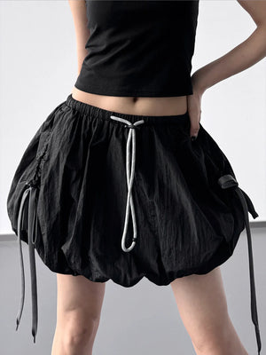 Black skirt with drawstring waist on a plain background