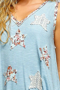 Light blue sleeveless top with star-shaped floral patches on a person.