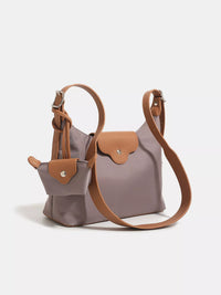 Gray handbag with brown accents on a white background