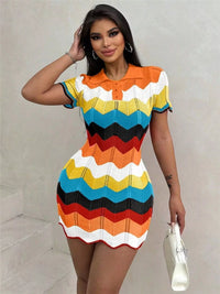 Woman wearing a colorful striped dress against a plain background