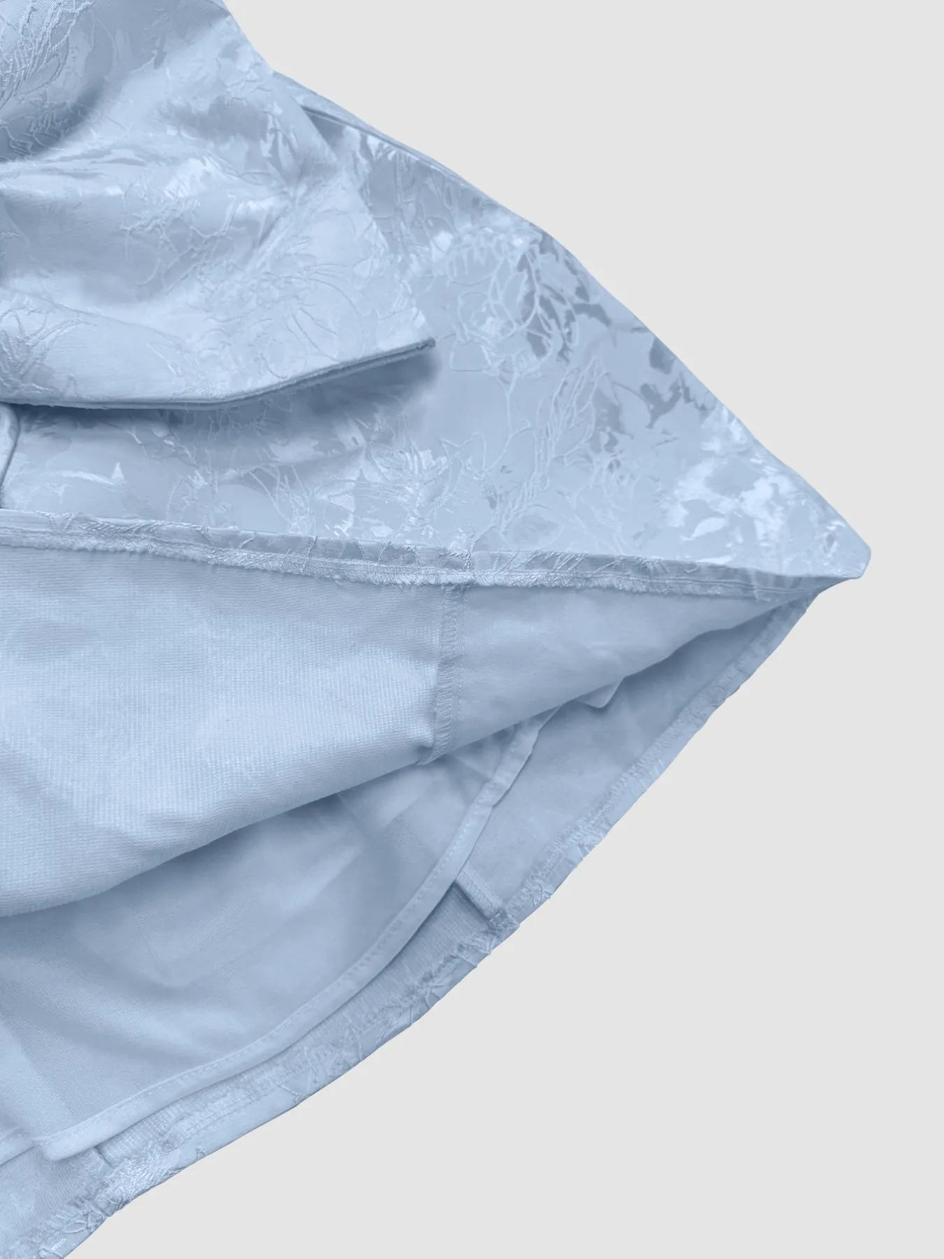 Light blue fabric with a subtle pattern on a light gray background