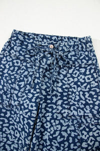 Blue pants with white leopard print pattern on a white background
