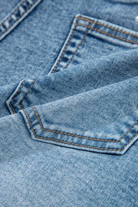 Close-up of blue denim fabric with stitching details