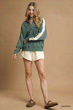 Woman wearing a green and white outfit on a beige background