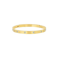 A matte gold bangle bracelet with eight stones arranged in a pattern around the band.