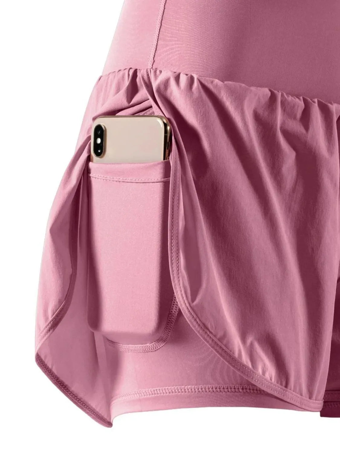 Pink skirt with a pocket containing a phone on a white background