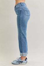 Light blue jeans worn by a person on a plain background