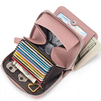 Pink wallet with card slots, money, and coins on a white background