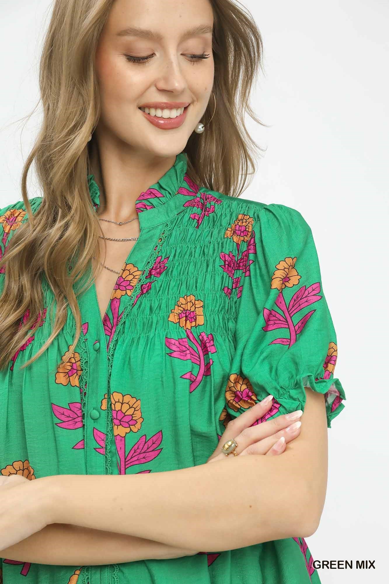 Woman wearing a green floral blouse with a white background