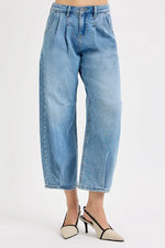 Light blue jeans worn by a person on a white background