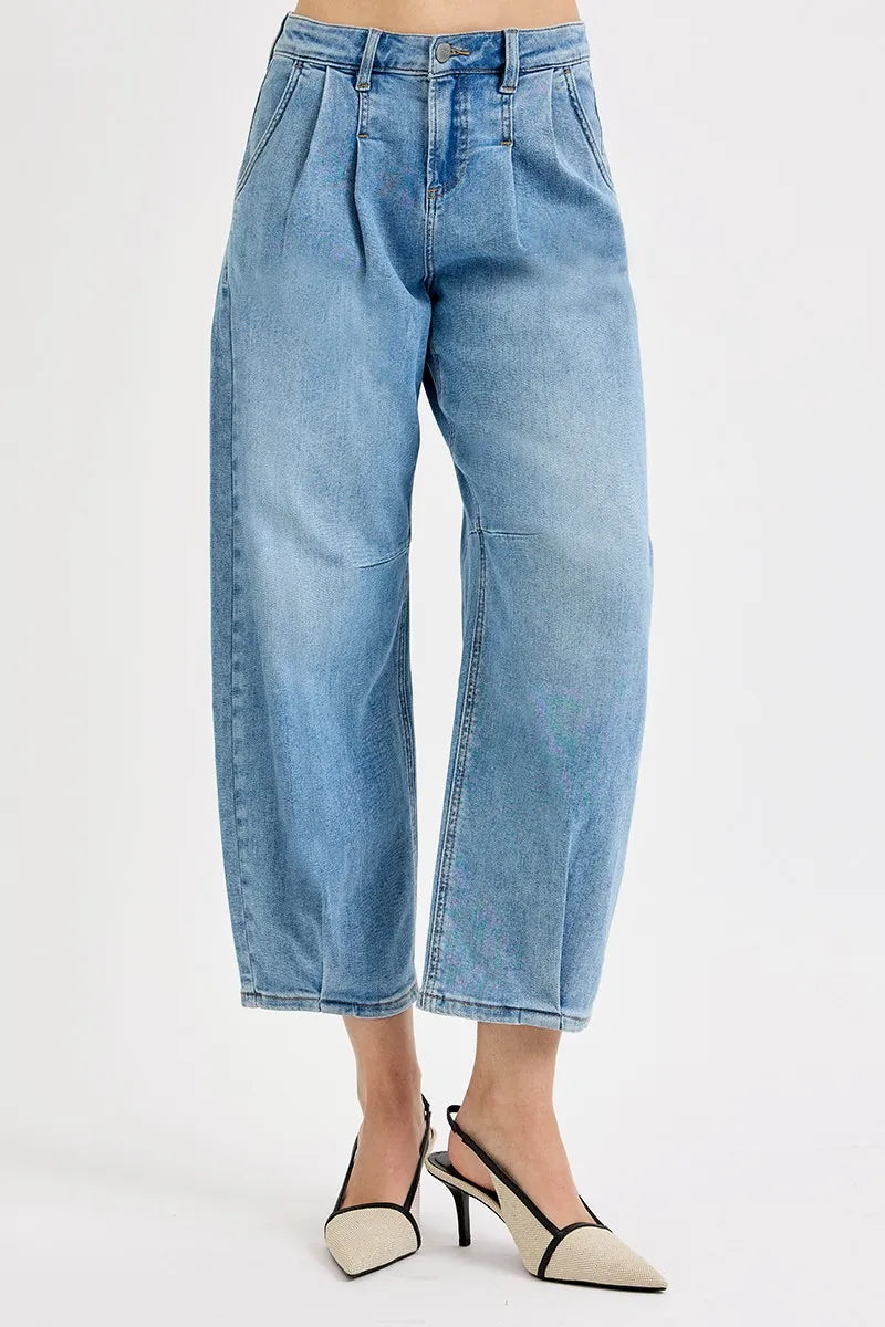 Light blue jeans worn by a person on a white background
