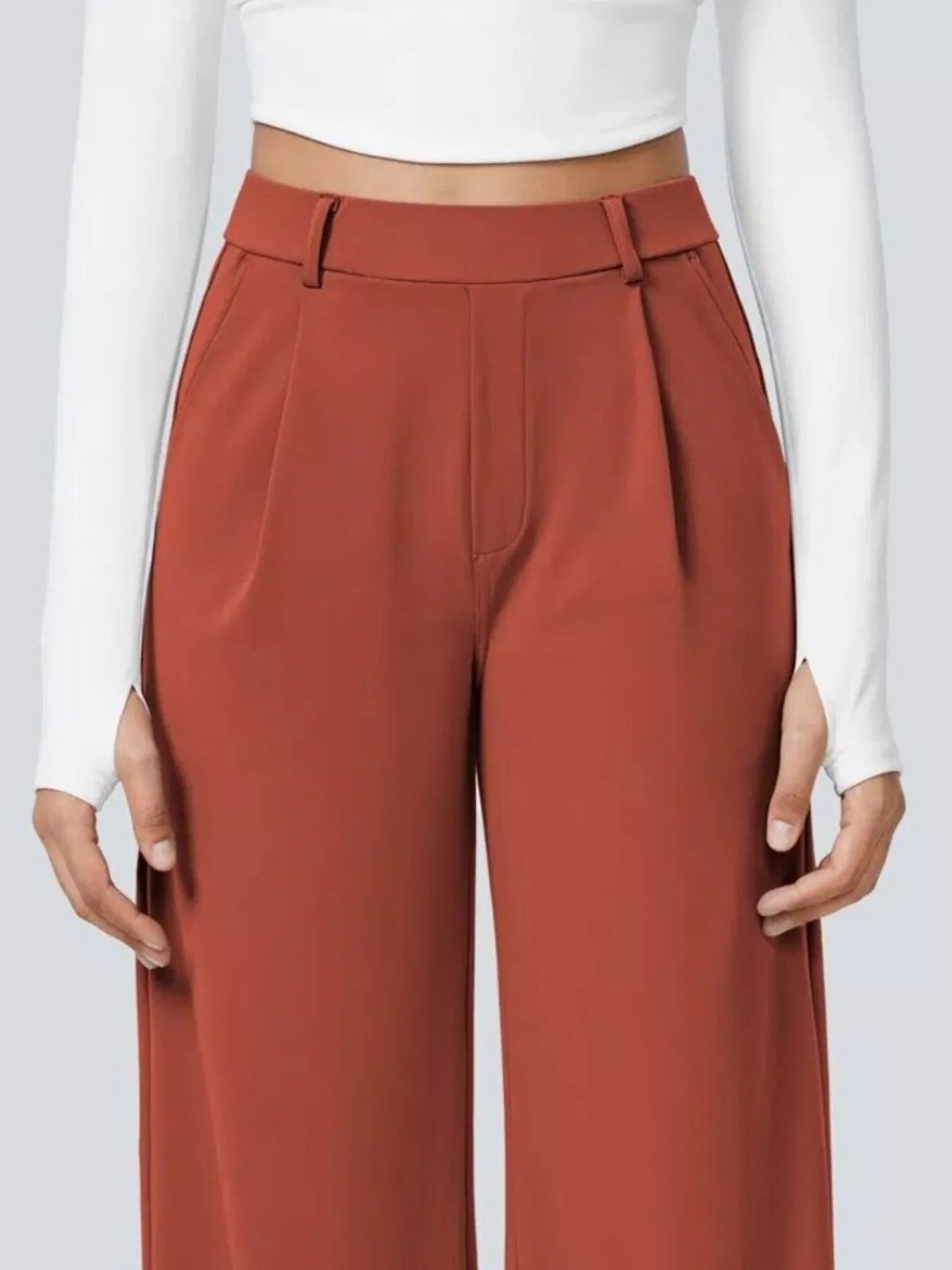 Brown pants worn by a person on a white background