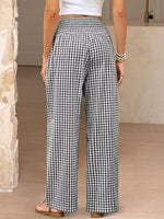 Person wearing black and white checkered pants indoors.