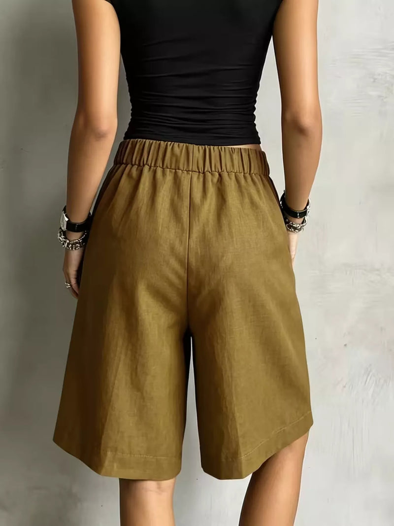 A lady showing the back of green High-Waisted Drawstring Shorts 
