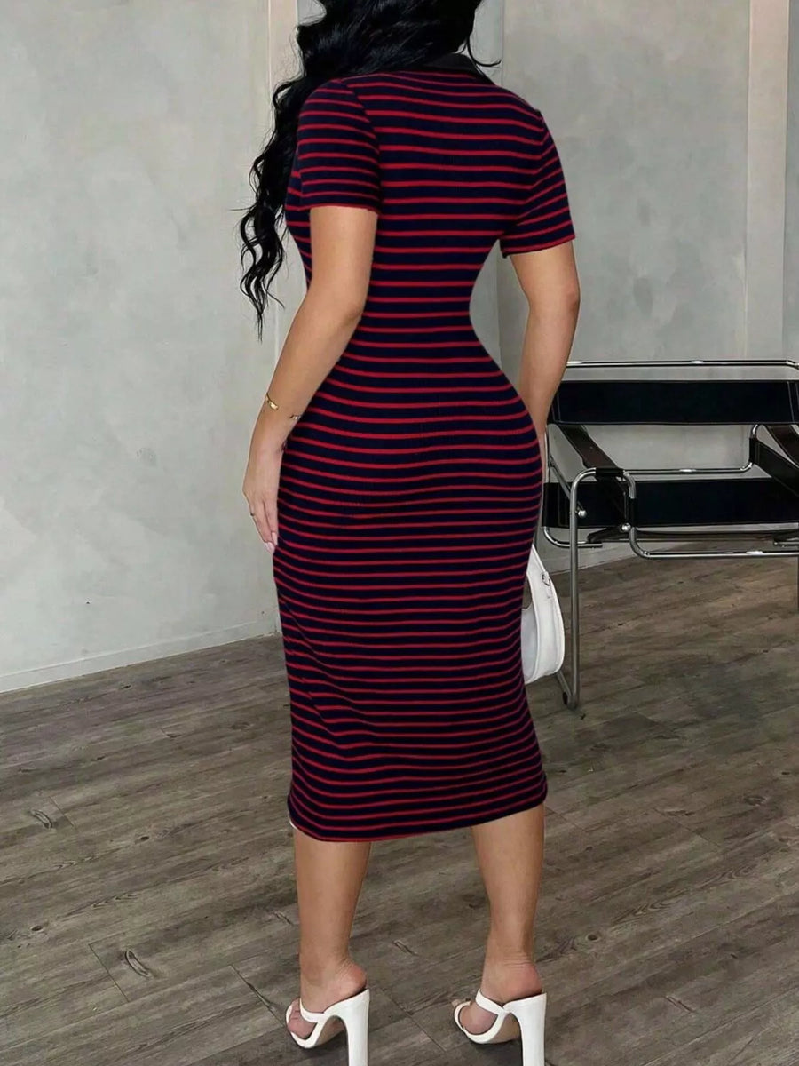 Woman wearing a black and red striped dress in an indoor setting.